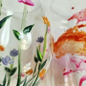 Detailaufnahme eines bemalten Glases mit Wiesenblumen in Rosa, Violett und Orange, aus dem Workshop Gläser bemalen in Wuppertal